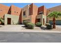A contemporary townhouse showing the front yard landscaping, a private drive, and one-car garage at 7601 E Roosevelt St # 1007, Scottsdale, AZ 85257