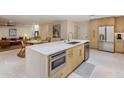 Modern kitchen with stainless steel appliances, a quartz countertop island, and open layout to living spaces at 8083 E Via Del Valle --, Scottsdale, AZ 85258