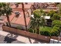 Private backyard with well-maintained landscaping, palm trees, and lush green space surrounded by block wall at 936 E Gila Ln, Chandler, AZ 85225