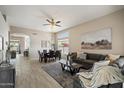 Open-concept living area with ample natural light, neutral tones, and stylish furnishings at 11650 W Pincushion Ct, Surprise, AZ 85378