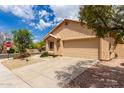 View of the front of a one-story beige stucco home with a tile roof on a sunny day at 11808 E Clinton St, Scottsdale, AZ 85259