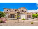 Two-story home showcasing a clay tile roof, stucco siding, and desert landscaping at 1253 E Ivanhoe Ct, Gilbert, AZ 85295