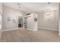 Spacious living space showcasing the open layout, modern light fixtures, and stylish sliding barn door feature at 1333 E Bermuda Bay Ct, Gilbert, AZ 85234