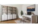 Modern office space featuring a contemporary desk, ample storage, and stylish decor with natural light at 15386 W Cottontail Ln, Surprise, AZ 85387