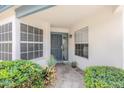 Inviting front porch with security screen door flanked by ample windows and lush, mature landscaping at 15815 N 4Th Dr, Phoenix, AZ 85023