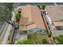 A high aerial view of the roof and backyard featuring desert landscaping and a small lawn at 15902 W Hearn Rd, Surprise, AZ 85379