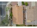 Birds-eye view of house with a tile roof, desert landscaping, and a small lawn at 15902 W Hearn Rd, Surprise, AZ 85379