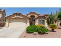 Charming home featuring a well-manicured front yard with desert landscaping, a two-car garage, and covered entryway at 16280 W Durango St, Goodyear, AZ 85338
