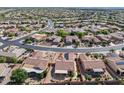 An aerial view showcases the layout of this beautiful home in a well-manicured neighborhood, with a fenced-in backyard at 16444 W Chuparosa Ln, Surprise, AZ 85387