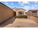 Inviting entrance with desert landscaping, colorful flowers, and a cozy front porch that welcomes you home at 16444 W Chuparosa Ln, Surprise, AZ 85387