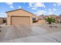 Inviting single-story home with a spacious driveway, two-car garage, and desert landscaping in a well-kept neighborhood at 16444 W Chuparosa Ln, Surprise, AZ 85387