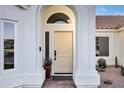 Inviting front entrance with a beautiful archway, a cream door, brick landing, and desert landscaping at 16662 S 37Th Way, Phoenix, AZ 85048