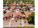 Aerial view of a well-maintained neighborhood featuring tile-roofed homes and lush landscaping in a desert community at 1910 E Citation Ln, Tempe, AZ 85284