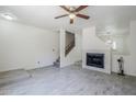 Inviting living room with a fireplace, ceiling fan, and ample natural light, creating a warm atmosphere at 1961 N Hartford St # 1055, Chandler, AZ 85225