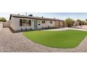 Charming one story home with an artificial lawn, desert landscaping, and a covered carport at 2111 N Van Ness Ave, Tempe, AZ 85288