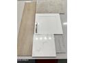 Selection of interior materials including white cabinetry, light wood-look flooring, carpet, and countertop samples at 23056 E Watford Dr, Queen Creek, AZ 85142