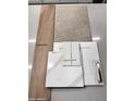 Home design material samples show carpet, tile, countertops, cabinet and flooring selections at 23064 E Watford Dr, Queen Creek, AZ 85142