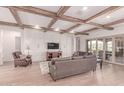 Elegant living room featuring hardwood floors, wood beam ceilings, and a decorative fireplace at 23126 N 45Th Pl, Phoenix, AZ 85050