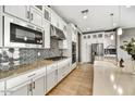 Well-equipped kitchen with sleek cabinetry, stainless steel appliances, and an eye-catching tile backsplash at 25326 N 19Th Dr, Phoenix, AZ 85085
