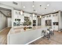 Stunning kitchen featuring a large island, ample cabinetry, stainless steel appliances, and stylish backsplash at 25326 N 19Th Dr, Phoenix, AZ 85085