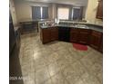 Spacious kitchen with dark countertops and an adjacent dining area perfect for gatherings at 3057 E Pinto Valley Rd, San Tan Valley, AZ 85143