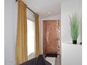 Stylish entryway featuring a metallic tile accent wall and a large window at 3122 E Kristal Way, Phoenix, AZ 85050