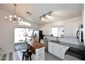 Bright and airy kitchen with white cabinetry, gray countertops, and a breakfast nook at 3122 E Kristal Way, Phoenix, AZ 85050