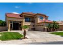 Inviting two-story home with a tile roof, a three-car garage, and meticulously maintained landscaping at 3644 E Del Rio St, Gilbert, AZ 85295