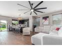Open-concept living space with hardwood floors, modern lighting, and ample seating, perfect for entertaining at 4135 E Waterman Ct, Gilbert, AZ 85297