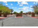Community entrance gate with stone accents and wrought iron, providing security and curb appeal at 41413 W James Ln, Maricopa, AZ 85138