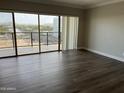 Bright living room features wood flooring and large windows providing spectacular city and mountain views at 4750 N Central Ave # A10, Phoenix, AZ 85012