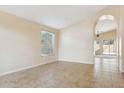 Bright living room with tile flooring, vaulted ceilings, and plenty of natural light at 5010 W Ivanhoe St, Chandler, AZ 85226