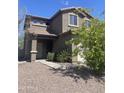 Charming two-story home featuring a tile roof, desert landscaping, and attached two-car garage at 5011 S 6Th Way, Phoenix, AZ 85040