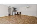 Open-plan living space with a kitchenette, tiled floors, and modern lighting at 5525 E Thomas Rd # R11, Phoenix, AZ 85018