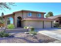 Charming two-story home featuring a three-car garage and a well-maintained front yard with a beautiful, red-tiled roof at 5879 E Marconi Ave, Scottsdale, AZ 85254