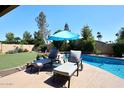 Lounge poolside with a clear view of the lovely pool and surrounding landscaped yard at 5879 E Marconi Ave, Scottsdale, AZ 85254