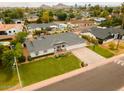 Eye-catching home with a sprawling lawn, three-car garage, lush trees, and beautiful mountain views at 6311 E Calle Rosa --, Scottsdale, AZ 85251