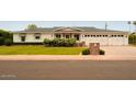 Charming single story home with an attached three-car garage and well maintained front lawn at 6311 E Calle Rosa --, Scottsdale, AZ 85251