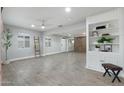 Bright living room with neutral paint, modern floors, a ceiling fan, and custom built-in shelving at 717 E Palmaire Ave, Phoenix, AZ 85020