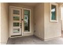 Contemporary front entrance featuring a modern door with glass inserts, sidelight window, and textured stucco at 734 W Winchester Dr, Chandler, AZ 85286