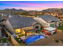 Aerial view of backyard oasis with pool, spa, pergola and outdoor kitchen at 8149 E Jaeger St, Mesa, AZ 85207