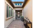 Charming home entrance with stone accents, brick walkway, and manicured landscaping at 8149 E Jaeger St, Mesa, AZ 85207