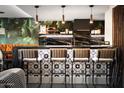 Stylish bar with designer tile, seating, and unique pendants creates a chic entertaining space at 8734 E Amelia Ave, Scottsdale, AZ 85251