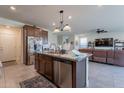 Eat-in kitchen featuring stainless steel appliances, a granite-topped center island and an open floor plan at 10035 E Trent Ave, Mesa, AZ 85212