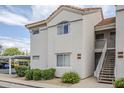 Charming condo exterior with stairs, covered parking, lush greenery and neutral paint at 10401 N 52Nd St # 205, Paradise Valley, AZ 85253