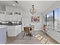 Bright kitchen and dining area featuring modern appliances, an elegant chandelier, and lots of natural light at 10733 W Clover Way, Avondale, AZ 85392