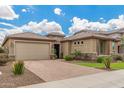 Charming home featuring a well-maintained front yard and a two-car garage with brick paved driveway at 10741 W Paso Trl, Peoria, AZ 85383