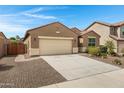 Charming single-story home featuring a desert landscaped front yard and an attached two car garage at 10743 W Bronco Trl, Peoria, AZ 85383