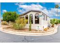 Corner lot home featuring desert landscaping and mature trees with white trims at 111 S Greenfield Rd # 119, Mesa, AZ 85206