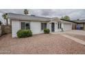 Charming single-story home with a well-maintained front yard and an attached two-car garage at 12228 S Pewaukee St, Phoenix, AZ 85044